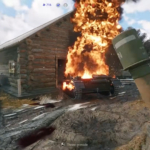 Burning tank exploding near wooden building with massive fire and smoke.