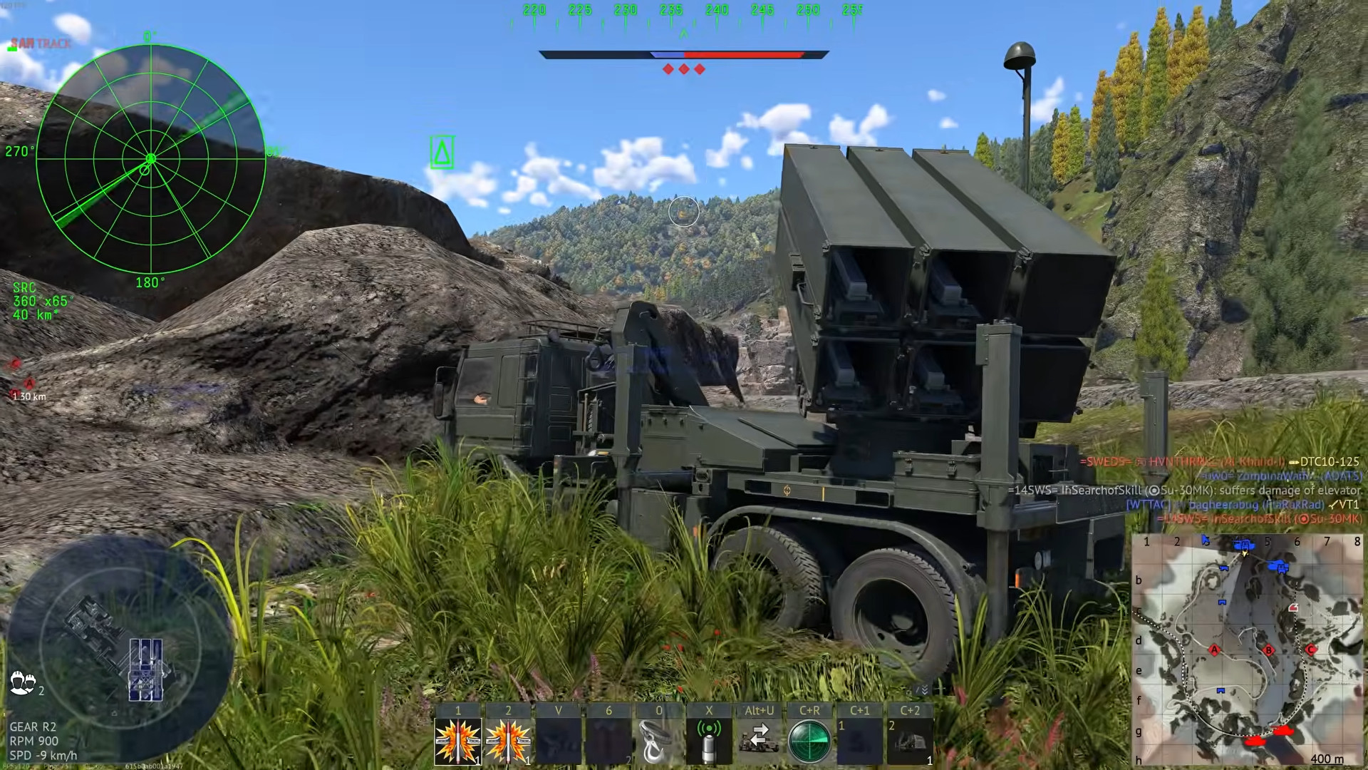 NASAMS SAM launcher positioned in rocky mountain pass with radar display active in top-left, missile tubes elevated skyward.